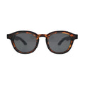 Round tortoise sunglasses front view — thick amber acetate frame with smoke grey tinted lenses, unisex retro style