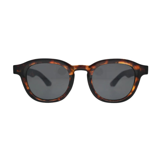 Round tortoise sunglasses front view — thick amber acetate frame with smoke grey tinted lenses, unisex retro style