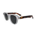 Three-quarter view of clear frame tortoise sunglasses with chunky plastic build and smoke grey lenses