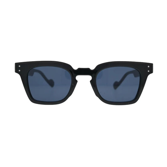 Front view of black square sunglasses with blue lenses showing thick frame, notched cutout bridge, and double silver rivets on temples