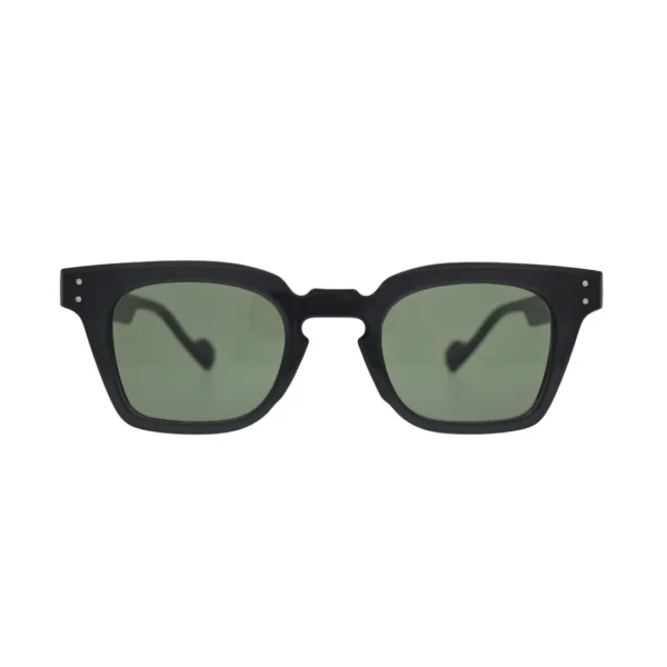 Front view of black square sunglasses with green lenses showing thick frame, notched cutout bridge, and silver rivet detail on temples