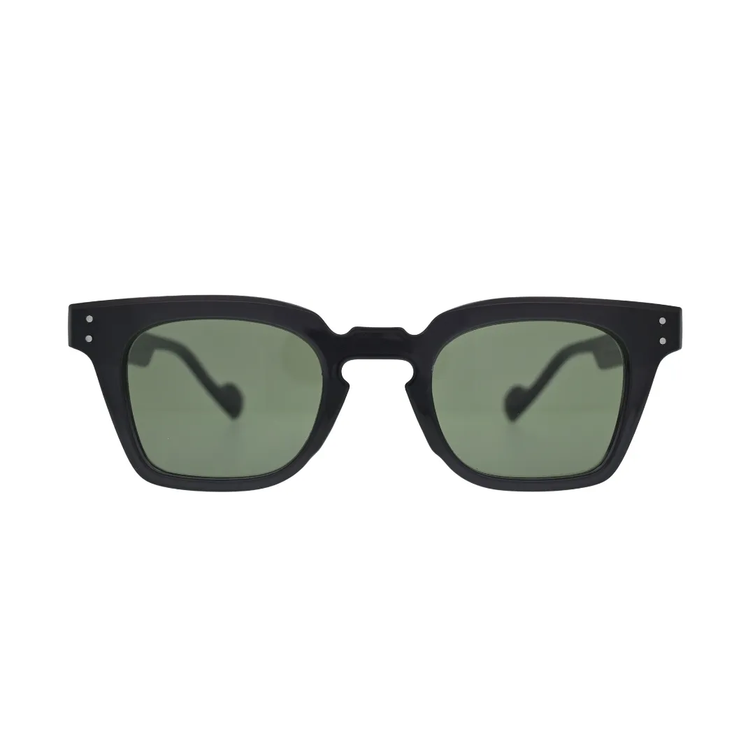 Front view of black square sunglasses with green lenses showing thick frame, notched cutout bridge, and silver rivet detail on temples